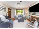 Bright living room with a fireplace, large window, and comfortable seating, perfect for relaxation and entertainment at 1102 E 13Th St, Kannapolis, NC 28083