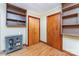 Room with wood floors, built-in shelves, closet doors, and blue cabinet for storage at 1102 E 13Th St, Kannapolis, NC 28083