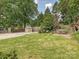 Large backyard with green lawn, wooden fence, storage shed, and patio area at 1139 Yale Pl, Charlotte, NC 28209