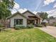 Beautiful home exterior with a well-manicured lawn, covered patio, and tasteful landscaping at 1139 Yale Pl, Charlotte, NC 28209