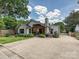 Lovely home exterior featuring a spacious driveway, landscaped yard, and inviting covered patio at 1139 Yale Pl, Charlotte, NC 28209