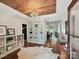 Elegant foyer with custom built-ins, hardwood floors, unique light fixture, and wood-paneled ceiling at 1139 Yale Pl, Charlotte, NC 28209