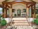 Inviting front porch with brick steps, detailed wood beams, and a cozy bench seating area at 1139 Yale Pl, Charlotte, NC 28209