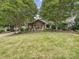 Charming home with lush front lawn and mature trees, showcasing curb appeal at 1139 Yale Pl, Charlotte, NC 28209