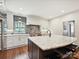 Kitchen showcasing white cabinets, marble counters, stainless appliances and hardwood flooring at 1139 Yale Pl, Charlotte, NC 28209