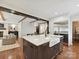 Open concept kitchen featuring island with white marble countertops, stainless fridge, and hardwood flooring at 1139 Yale Pl, Charlotte, NC 28209