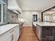 Spacious kitchen featuring modern appliances, marble counters, and beautiful dark hardwood flooring at 1139 Yale Pl, Charlotte, NC 28209