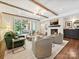 Inviting living room featuring a fireplace, wood beams, and a sliding glass door leading to the patio at 1139 Yale Pl, Charlotte, NC 28209