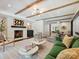 Bright living room with a brick fireplace, beamed ceilings, and designer furnishings at 1139 Yale Pl, Charlotte, NC 28209