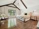 Main bedroom featuring hardwood floors, beamed ceilings, and lots of natural light at 1139 Yale Pl, Charlotte, NC 28209