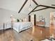 Main bedroom featuring vaulted beamed ceilings, hardwood floors, and lots of natural light at 1139 Yale Pl, Charlotte, NC 28209