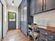 Mud Room featuring blue built in cabinets, wooden counters, and hardwood floors at 1139 Yale Pl, Charlotte, NC 28209