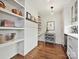 Pantry with white shelving, ample storage, stylish decor, and hardwood floors at 1139 Yale Pl, Charlotte, NC 28209