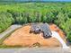 Newly built home on a vast lot, featuring a modern design, driveway and surrounded by mature trees at 124 Starboard Ln, Statesville, NC 28677