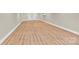 Finished basement with wood-look flooring, white trim, and access to storage space at 124 Starboard Ln, Statesville, NC 28677