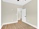 A light-filled bedroom with wood-look floors, neutral walls and open doorway is ready for its new owner at 124 Starboard Ln, Statesville, NC 28677