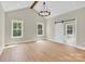 Bright bedroom features vaulted ceiling, wood beam, and a view of the ensuite bathroom through sliding barn door at 124 Starboard Ln, Statesville, NC 28677
