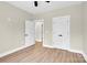 An open doorway and roomy closet complement this well-lit bedroom, complete with wood-look floors and neutral walls at 124 Starboard Ln, Statesville, NC 28677