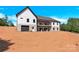 Rear exterior view of home with a basement, covered patio, and a three-car garage at 124 Starboard Ln, Statesville, NC 28677