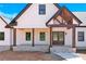 Charming front porch with wood pillars, brick accents, and a double door entry at 124 Starboard Ln, Statesville, NC 28677