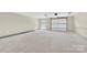 The spacious garage features natural light, overhead doors and offers a blank canvas for a homeowner at 124 Starboard Ln, Statesville, NC 28677