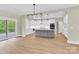A modern, open concept kitchen features sleek white cabinets, a gray island, and stainless steel appliances at 124 Starboard Ln, Statesville, NC 28677