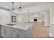 Open-concept kitchen featuring granite countertops and a view into the adjacent living area with fireplace and built-in shelving at 124 Starboard Ln, Statesville, NC 28677