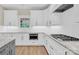 The modern kitchen features bright white cabinets, granite countertops, stainless steel appliances, and a gas stovetop at 124 Starboard Ln, Statesville, NC 28677