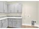 Laundry room featuring gray cabinets, granite countertops, and a utility sink with hookups at 124 Starboard Ln, Statesville, NC 28677