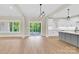 The living room has a direct view of the modern kitchen and access to an outdoor deck at 124 Starboard Ln, Statesville, NC 28677