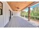 Spacious outdoor porch featuring a wood ceiling with fans and a scenic view of the surrounding trees at 124 Starboard Ln, Statesville, NC 28677