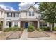 Charming townhome featuring a blue front door, brick facade and manicured landscaping at 12749 Mosby Ln, Charlotte, NC 28273