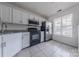 Kitchen featuring stainless appliances, granite counters, and white cabinetry at 12749 Mosby Ln, Charlotte, NC 28273
