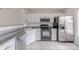 Kitchen featuring stainless appliances, granite counters, and white cabinetry at 12749 Mosby Ln, Charlotte, NC 28273
