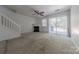 Spacious living room featuring a fireplace, stairs, and sliding doors to the exterior at 12749 Mosby Ln, Charlotte, NC 28273