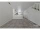 Bright living room offers tile flooring and a view of the kitchen and staircase at 12749 Mosby Ln, Charlotte, NC 28273