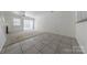 Open-concept living room featuring tile and carpet flooring and abundant natural light at 12749 Mosby Ln, Charlotte, NC 28273
