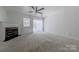 Bright living room features a fireplace, neutral carpet, and sliding glass doors at 12749 Mosby Ln, Charlotte, NC 28273