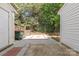 Backyard patio with red and gray pavers, enclosed wooden fence, and a small grassy area at 12749 Mosby Ln, Charlotte, NC 28273