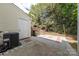 Backyard patio with a partial view of a white door, a brick paver design, and an enclosed wooden fence at 12749 Mosby Ln, Charlotte, NC 28273