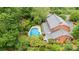 Aerial view of a brick home with a pool, screened porch, and lush landscaping at 1285 10Th Street Nw Blvd, Hickory, NC 28601