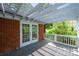Covered porch with weathered wood flooring and view of the backyard greenery at 1285 10Th Street Nw Blvd, Hickory, NC 28601