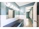 Bathroom with double sink, dark countertops, neutral colors and tiled walls and floors at 1285 10Th Street Nw Blvd, Hickory, NC 28601
