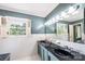Bathroom with double sink, dark countertops, neutral colors and tiled walls and floors at 1285 10Th Street Nw Blvd, Hickory, NC 28601