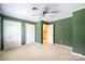 Neutral bedroom with white trim, green walls, carpeted floor and double closet at 1285 10Th Street Nw Blvd, Hickory, NC 28601