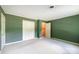 Neutral bedroom with white trim, green walls, carpeted floor and double closet at 1285 10Th Street Nw Blvd, Hickory, NC 28601