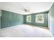 Empty bedroom with two windows, neutral carpet, and classic ceiling fan at 1285 10Th Street Nw Blvd, Hickory, NC 28601
