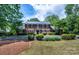 Beautiful brick home featuring a manicured front yard and classic black shutters at 1285 10Th Street Nw Blvd, Hickory, NC 28601