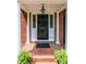 Classic front door with sidelights and decorative columns on a brick porch at 1285 10Th Street Nw Blvd, Hickory, NC 28601