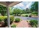 View of the landscaped front yard from the porch, showcasing lush greenery and a brick walkway at 1285 10Th Street Nw Blvd, Hickory, NC 28601